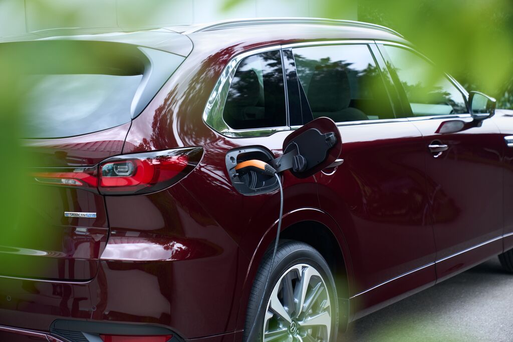 Medium-2023_CX-80_GER-LHD_C053_EXT_RQ_PHEV_Charging_Lifestyle_ArtisanRed_INT_PremiumModern_WhiteNappaLeather_High+.jpg